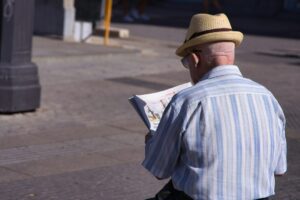 Two people study a Hebrew street map while one points toward an intersection.