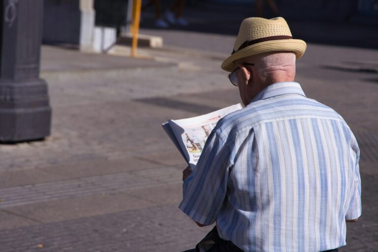 Two people study a Hebrew street map while one points toward an intersection.