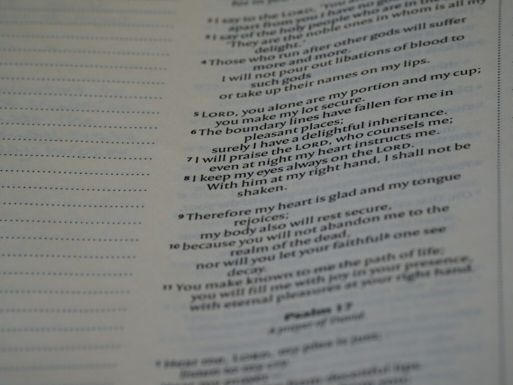 Person reading a Hebrew menu with Hebrew text, food descriptions, and handwritten notes at a table.