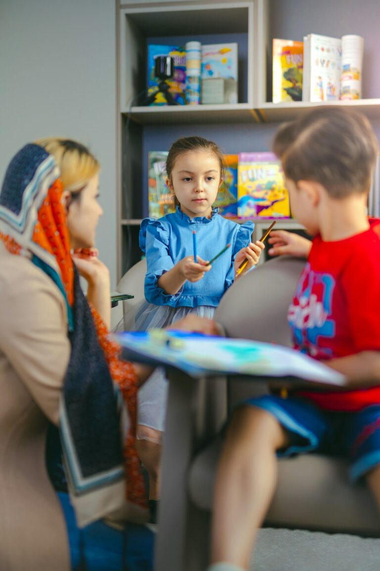 Child watching a Hebrew cartoon beside picture cards and colorful Hebrew vocabulary notes.