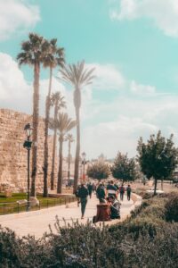 Traveler reviewing Hebrew phrases beside a passport, map, and handwritten vocabulary notes.
